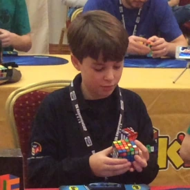 Will Faust as a kid solving a Rubik's Cube at a speedcubing competition
