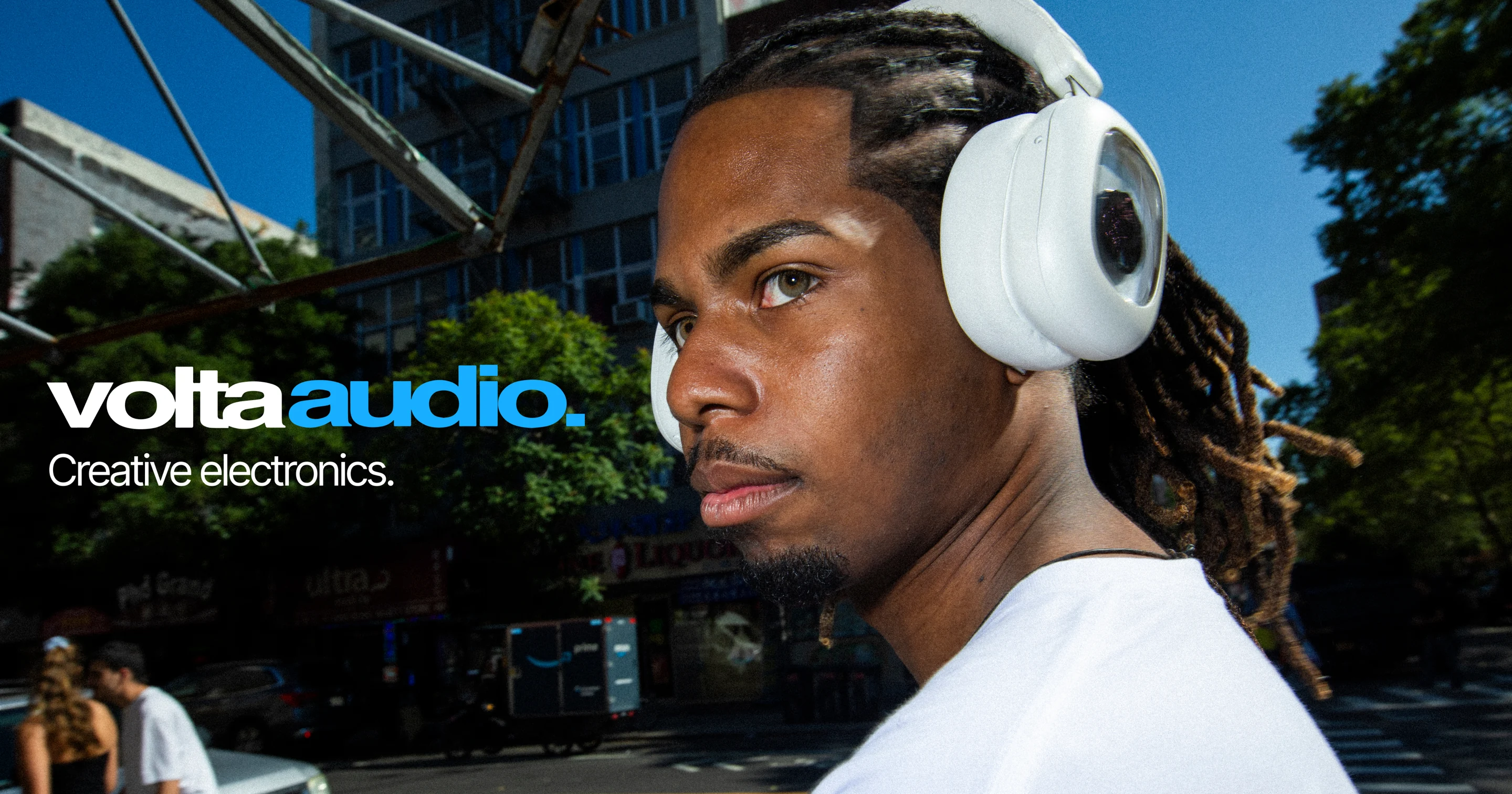 Man wearing white Volta Audio ferrofluid headphones on a New York City street
